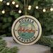A circular ornament with the text "DOUALA CAMERON" and an illustration of a cityscape with a river and bridge.