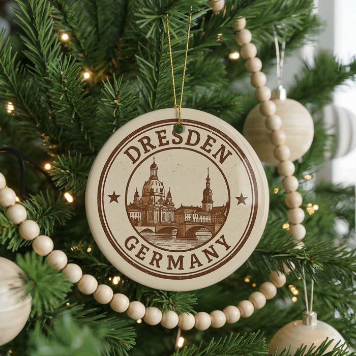 A circular ornament on a Christmas tree, featuring the image of Dresden, Germany, with the text "Dresden Germany" prominently displayed.