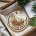 A circular ornament with the text "Dresden Germany" printed on it, hanging from a string.
