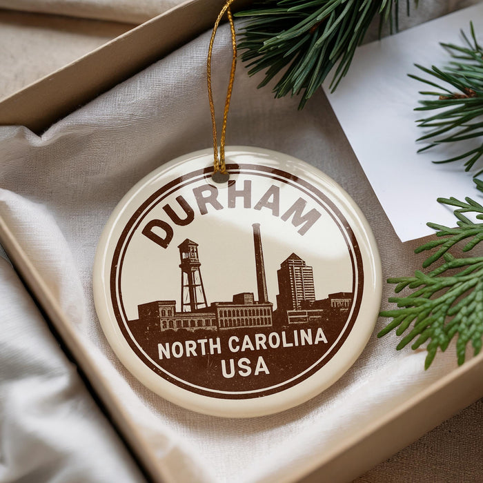 A decorative ornament with the text "DURHAM NORTH CAROLINA USA" printed on it, hanging from a string.