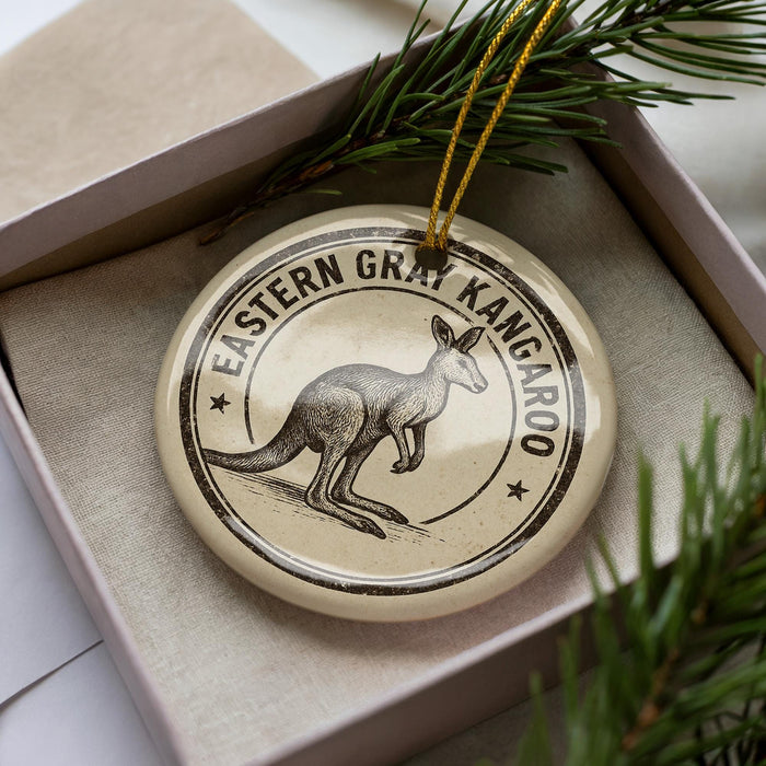 A circular ornament with a kangaroo illustration and the text "EASTERN GRAY KANGAROO" is displayed in a box, surrounded by pine branches.