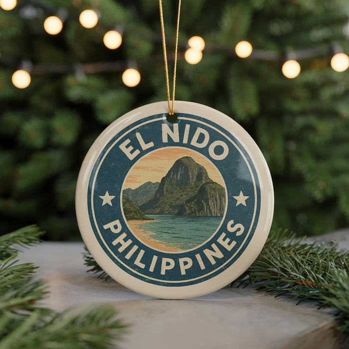 A round ornament with the text "EL NIDO PHILIPPINES" and a mountain landscape design, hanging from a string.