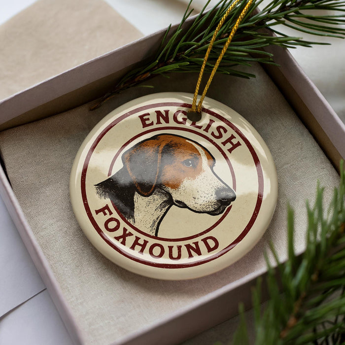 A circular ornament featuring a beagle dog's head, with the text "English Foxhound" written around the edge.