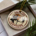 A circular ornament featuring a beagle dog's head, with the text "English Foxhound" written around the edge.