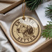 A round ornament with the text "ENGLISH SETTER" and a depiction of a dog's head is displayed in a box with pine branches.