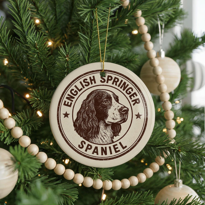 A Christmas tree decorated with ornaments, including a circular ornament with the text "English Springer Spaniel" and a picture of a dog's head.
