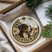 A round ornament featuring a dog's head and the text "ENTLEBUCER MOUNTAIN DOG" is displayed in a box with pine branches.