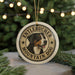 A round ornament featuring a dog's head and the text "Entlebucher Mountain Dog" is displayed in front of a Christmas tree with twinkling lights.