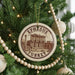 A circular ornament on a Christmas tree, featuring an illustration of the ancient city of Ephesus, Turkey.