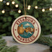 A circular ornament with the text "ESSAQUIRA MOROCCO" and an illustration of a cityscape, hanging from a string.