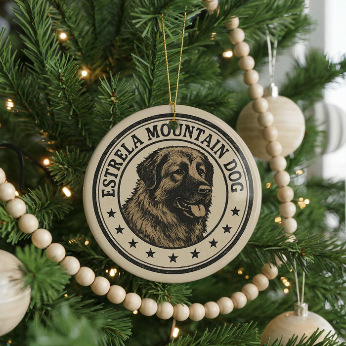 A Christmas tree decorated with ornaments, including a circular ornament with a dog image and the text "ESTRELLA MOUNTAIN DOG" around it.