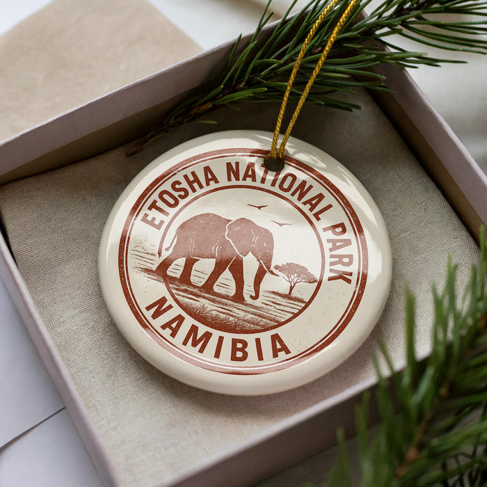 A circular ornament with the text "ETOSHA NATIONAL PARK NAMIBIA" printed on it, surrounded by a decorative string.