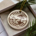 A circular ornament with the text "EVERGLADES NATIONAL PARK" printed on it, surrounded by pine branches and greenery.