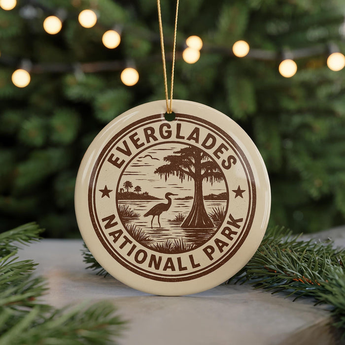 A circular ornament with the text "EVERGLADES NATIONAL PARK" and a graphic of a bird standing on a tree, surrounded by greenery.