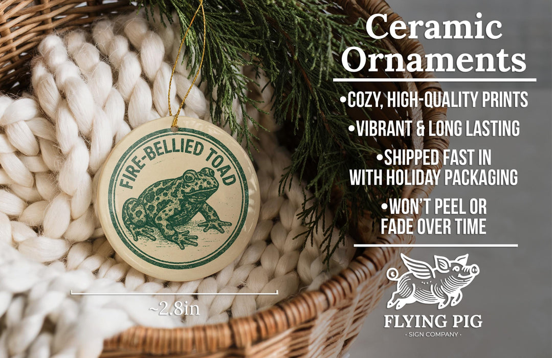 Ceramic ornaments, featuring a fire-bellied toad design, are displayed in a woven basket.