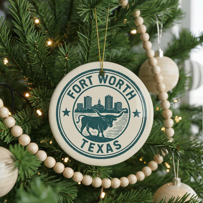A Christmas tree decorated with ornaments, including a circular ornament with the text "Fort Worth, TX" and a graphic of a bull.