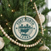 A Christmas tree decorated with ornaments, including a circular ornament with the text "Fort Worth, TX" and a graphic of a bull.