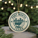 A circular ornament with the text "FORT WORTH TEXAS" and an illustration of a bull, surrounded by lights and greenery.