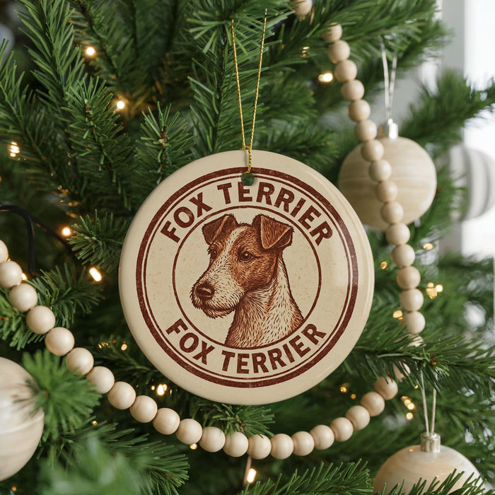 A round ornament on a Christmas tree featuring a fox terrier dog's head, with the text "FOX TERRIER" around the edge.