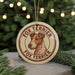 A round ornament featuring a fox terrier dog's head, with the text "FOX TERRIER" and "FOX TERRIER" written around the edge.