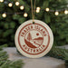 A circular ornament with the text "FASTER ISLAND AUSTRALIA" printed on it, hanging from a string.