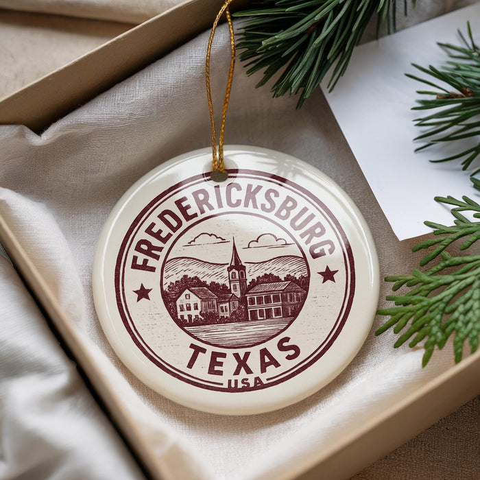 A decorative ornament with the text "FREDERICKSBURG TEXAS USA" printed on it, hanging from a string.