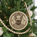 A round ornament with a bulldog image and the text "French Bulldog" is hanging on a Christmas tree.