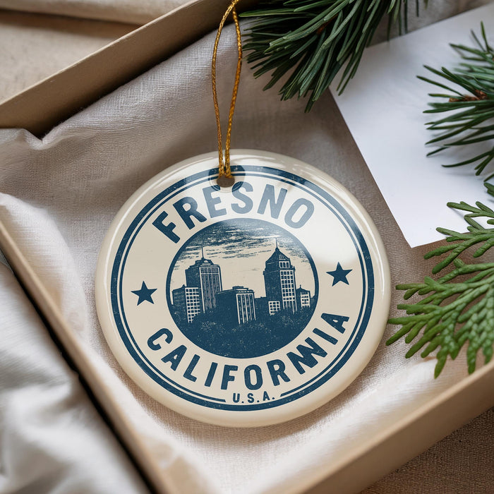 A circular ornament with the text "FRESNO CALIFORNIA" and a graphic of a city skyline, hanging from a string.