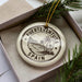 A decorative ornament with the text "FUERTEVENTURA SPAIN" printed on it, surrounded by palm trees and a beach scene.