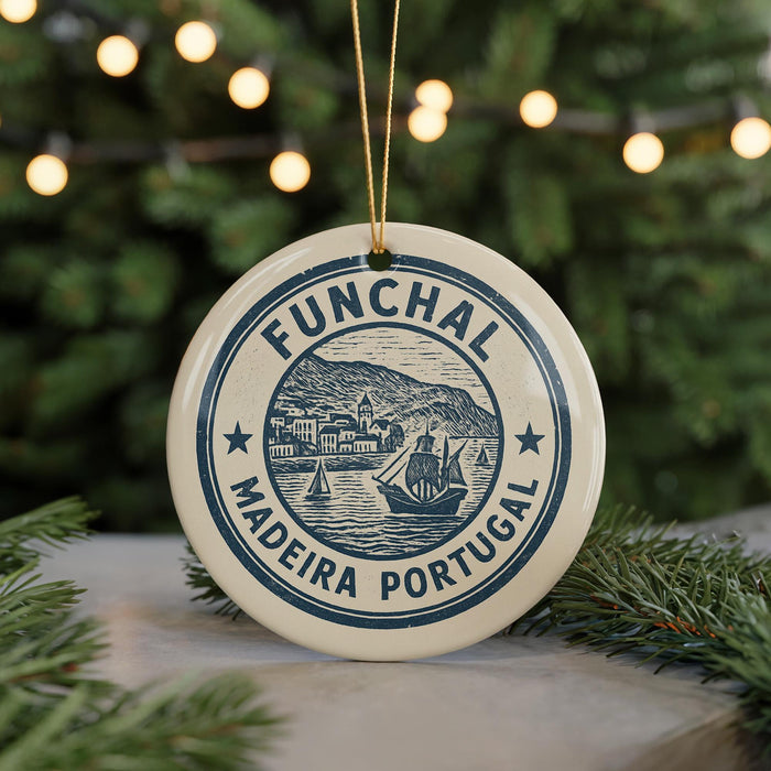 A circular ornament with the text "FUNCHAL MADEIRA PORTUGAL" printed on it, featuring a ship and a coastal scene.