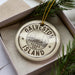 A circular ornament with the text "GALVESTON ISLAND" printed on it, surrounded by pine branches.