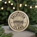 A circular ornament with the text "GALVESTON TEXAS ISLAND" printed on it, hanging from a string.