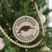 A Christmas tree decorated with ornaments, including a round ornament with a graphic of a dolphin and the text "Ganges River Dolphin".