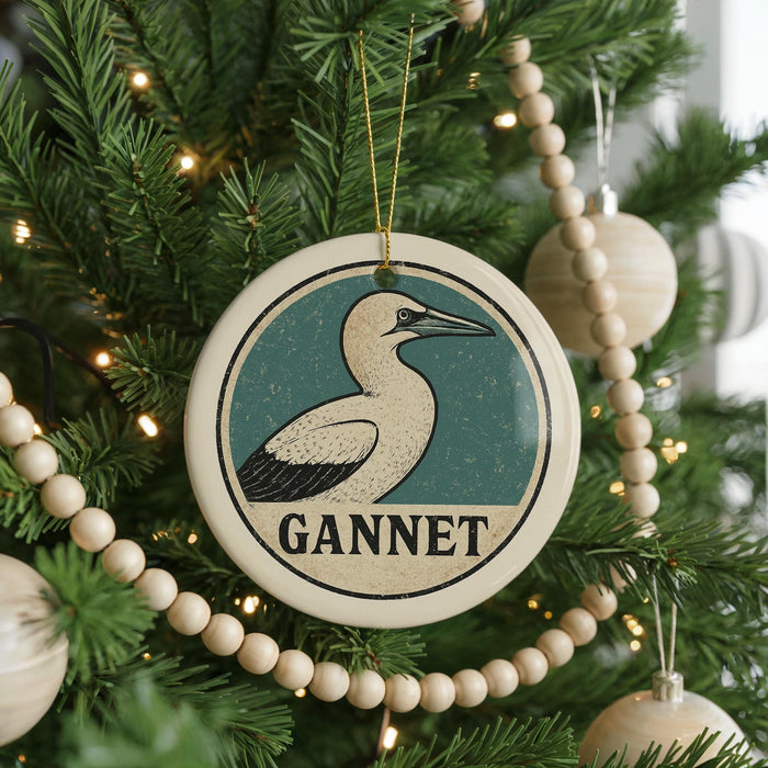 A Christmas tree decorated with ornaments, including a circular ornament with a bird image and the word "GANNET" written on it.
