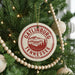 A Christmas tree decorated with ornaments, including a circular ornament with the text "GATLINBURG TENNESSEE USA" and a mountain landscape design.