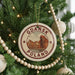 A circular ornament on a Christmas tree, featuring a picture of a city and the text "Gdansk Poland".