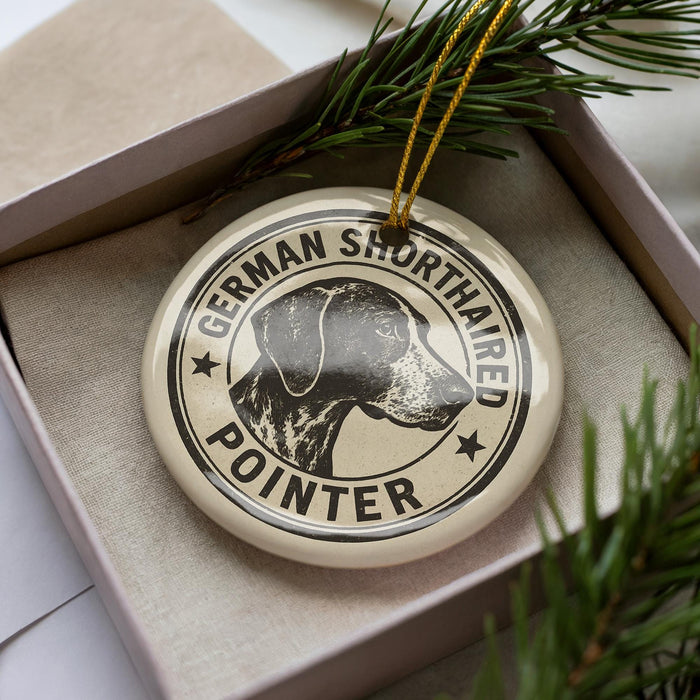 A circular ornament with a black and white illustration of a German Shorthaired Pointer dog, surrounded by text that reads "German Shorthaired Pointer".