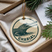 A circular ornament with a crocodile image and the word "GHARIAL" printed on it, hanging from a string.