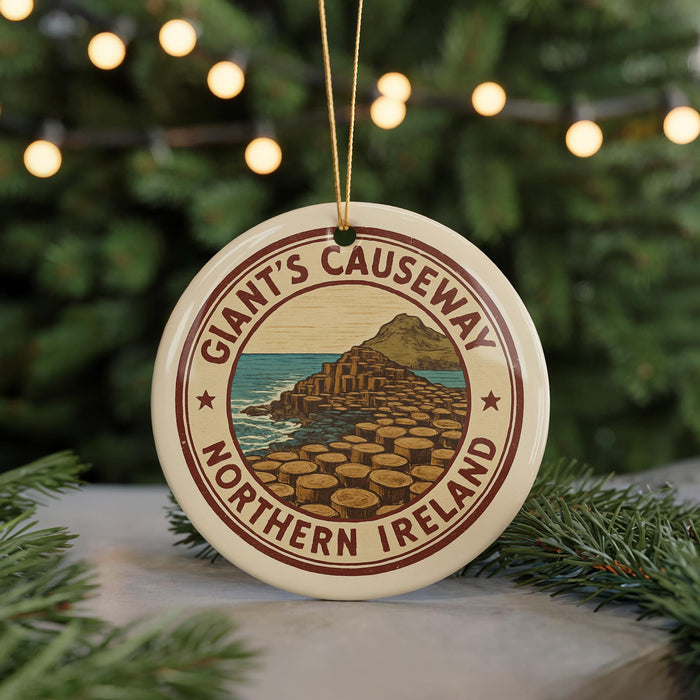 A circular ornament with the text "Giant's Causeway" and "Northern Ireland" printed on it, hanging from a string.
