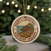 A circular ornament with the text "Giant's Causeway" and "Northern Ireland" printed on it, hanging from a string.
