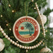 A round ornament on a Christmas tree, featuring a palm tree and the text "GILI TRAWANGAN INDONESIA".