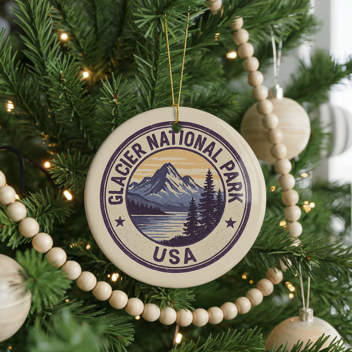 A Christmas tree decorated with ornaments, including a circular ornament with the text "GLACIER NATIONAL PARK USA" and a mountain landscape.