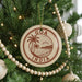 A Christmas tree decorated with ornaments, including a circular ornament with the text "GOD INDIA" and a palm tree design.