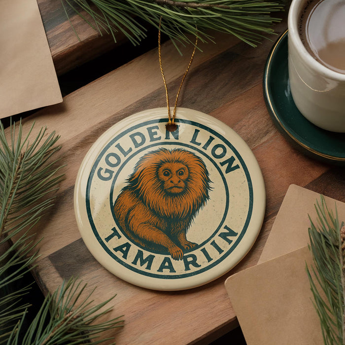 A round ornament featuring a golden lion, a type of primate, is displayed on a wooden surface alongside a cup of coffee and some pine branches.