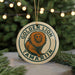 A round ornament with a lion image and the text "GOLDEN LION TAMARIN" on it, hanging from a string.