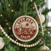 A circular ornament on a Christmas tree, featuring the text "GRANADA SPAIN" and an illustration of a cityscape.