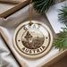 A circular ornament with the text "GRAZ AUSTRIA" and an illustration of a clock tower, hanging from a string.