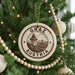 A Christmas tree decorated with ornaments, including a circular ornament with the text "GRAZ AUSTRIA" and a picture of a building.