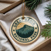 A circular ornament with the text "GREAT BASIN NATIONAL PARK" and a mountain landscape design, hanging from a string.