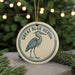 A circular ornament featuring a blue heron, with the text "GREAT BLUE HERON" written around the edge.